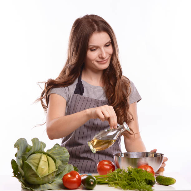 istock happy adult woman with various fresh vegetables on kitchen table looking at camera 1083429292