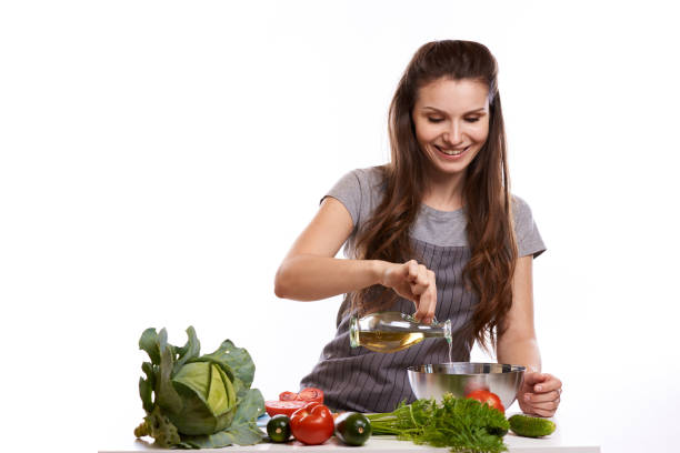 istock happy adult woman with various fresh vegetables on kitchen table looking at camera 1083429472