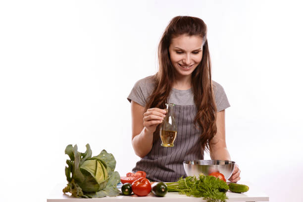 istock happy adult woman with various fresh vegetables on kitchen table looking at camera 1083429486