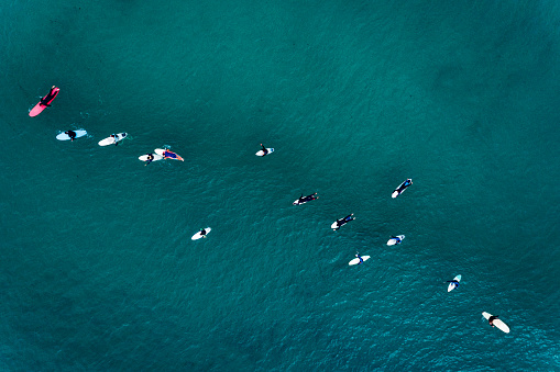 Aerial view of surfers in the ocean at the Baleal beach in Peniche, Portugal