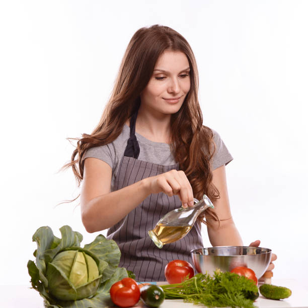istock happy adult woman with various fresh vegetables on kitchen table looking at camera 1083430184