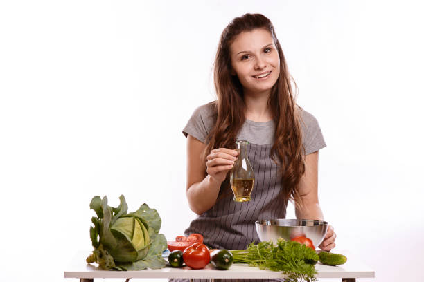 istock happy adult woman with various fresh vegetables on kitchen table looking at camera 1083430230