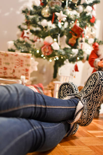 istock Young woman seat by the Christmas tree 1083431432