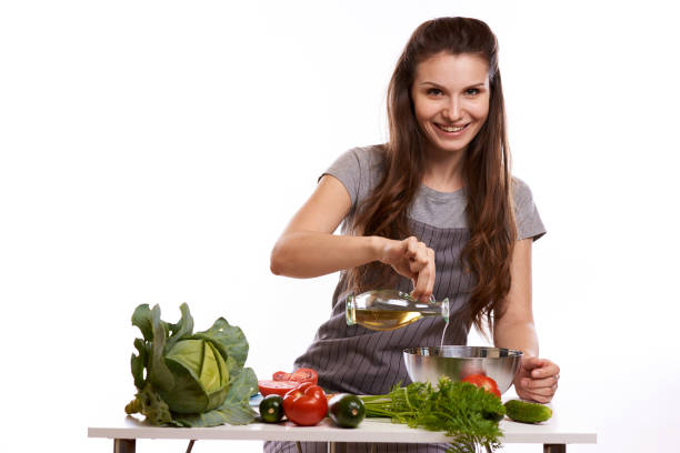 istock happy adult woman with various fresh vegetables on kitchen table looking at camera 1083431490