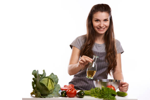 istock happy adult woman with various fresh vegetables on kitchen table looking at camera 1083431630