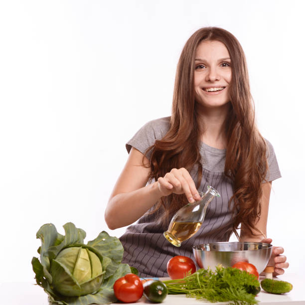 istock happy adult woman with various fresh vegetables on kitchen table looking at camera 1083432314