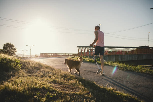 istock Handsome amputee and his dog in summer 1083435518