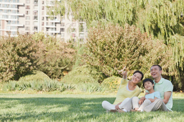 istock Chinese family relaxing in park 1083441542