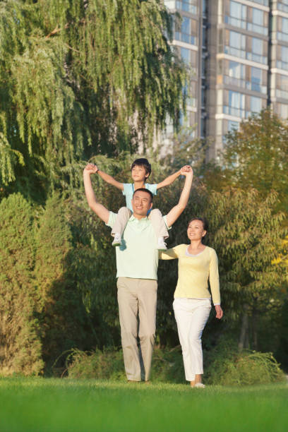 istock Chinese father carrying son on shoulders 1083441594