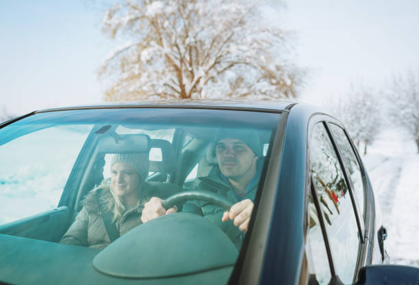 istock Couple driving car in snow 1083441664