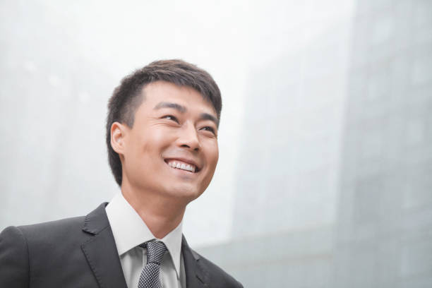 istock Chinese businessman looking away and smiling 1083443320