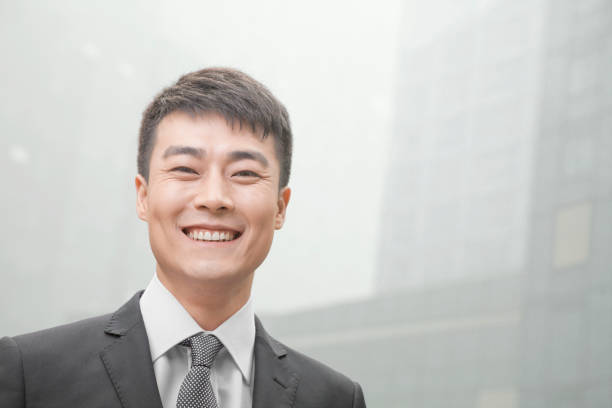 istock Chinese businessman looking at camera and smiling 1083443390