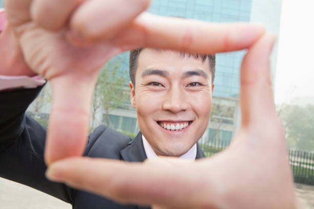 istock Chinese businessman looking through the frame gesture 1083443428