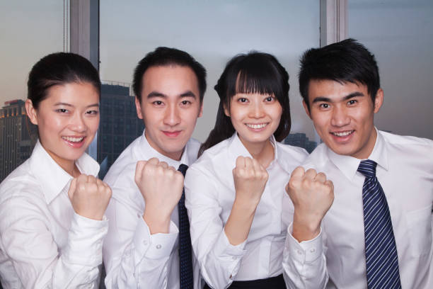 istock Chinese business people cheering in office and smiling 1083443586