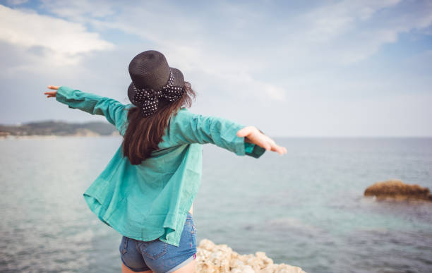 istock Woman admiring the view at seaside viewpoint 1083443588