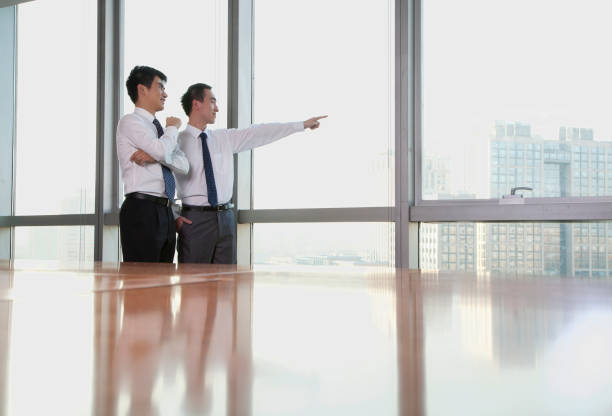 istock Chinese businessmen looking out window 1083443698