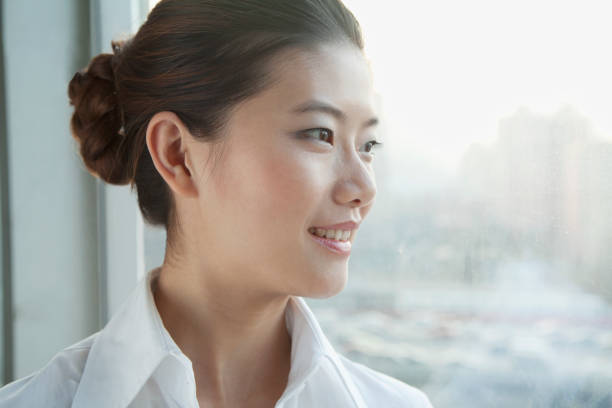 istock Chinese businesswoman looking out window 1083443702