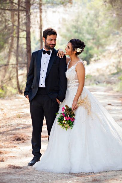 istock Happy wedding couple posing in nature 1083443734