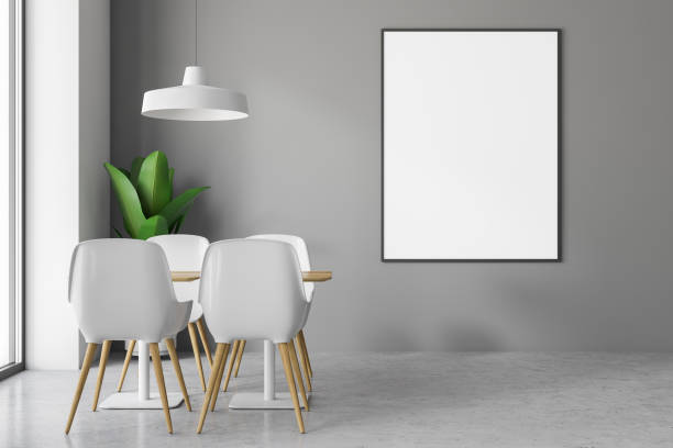 istock Table in gray cafe, white chairs and poster 1083457114