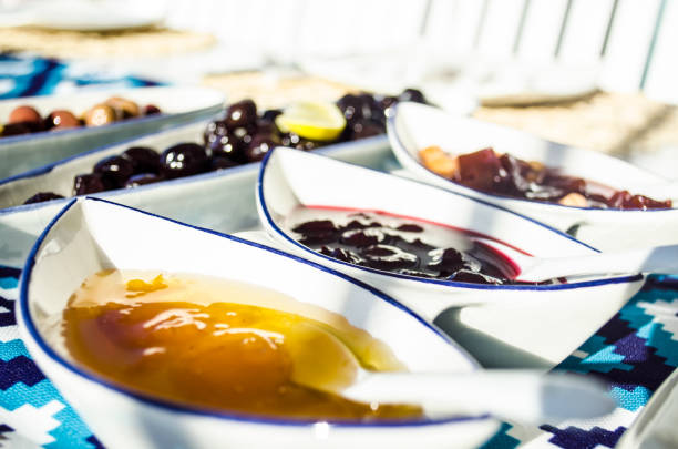 quince, cherry and apricot jams on breakfast table stock photo