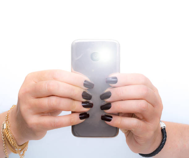 istock she is  taking a picture with her pink gold smartphone 1083457434