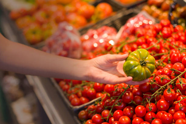 istock Female hand choosing vegetables in the store 1083458996