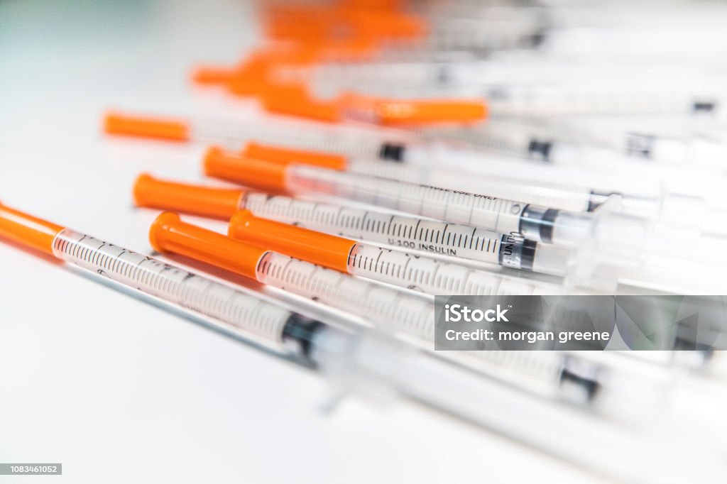 Close Up Shot Of A Pile Of Medical Insulin Needles With Orange