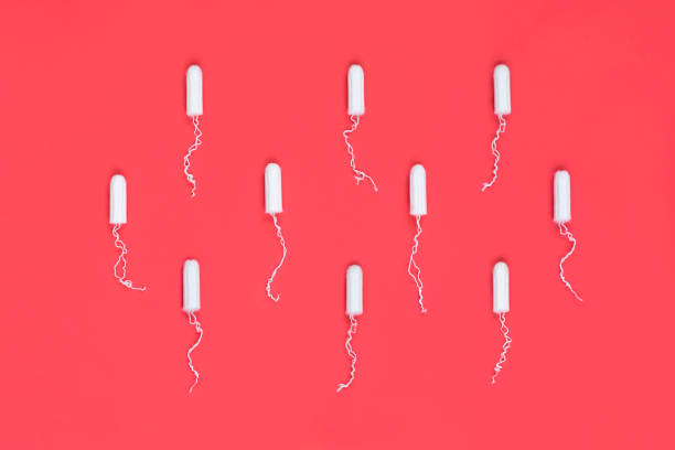Menstrual period concept. Woman hygiene protection. Cotton tampons on red background. Top view, flat lay. Menstrual period concept. Woman hygiene protection. Cotton tampons on red background. Top view, flat lay. continuity photos stock pictures, royalty-free photos & images