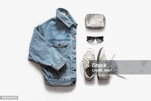 Casual Fashion Clothes And Accessory Set On White Background Jean Jacket Sneakers Sunglasses Bag Flat Lay Top View Stock Photo - Download Image Now