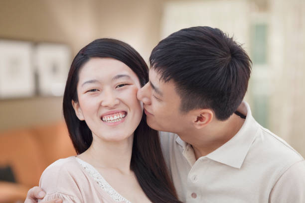 istock Chinese man kissing girlfriend 1083467326