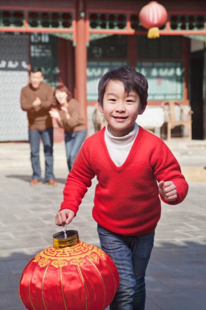 Chinese boy carrying traditional lantern