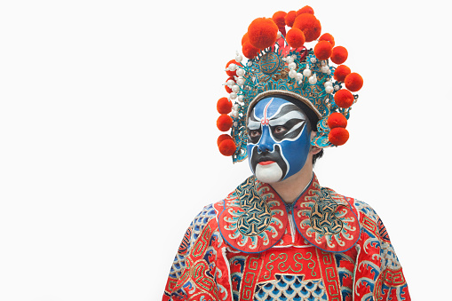Man in traditional Chinese opera costume looking away