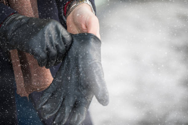 istock Man putting his winter gloves on 1083469794