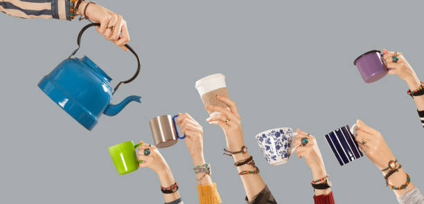 istock raised arms hands holding coffee cups 1083472284