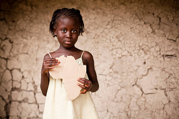 Black girl holding a piece of cardboard shaped like Africa An African girl holding an Africa shaped sign.
See my portfolio for more images of African people. poverty child ethnic indigenous culture stock pictures, royalty-free photos & images