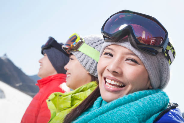 istock Smiling Chinese friends on ski resort 1083472428