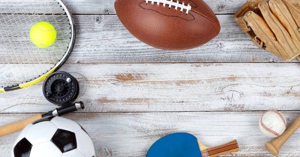 istock Various sports equipment on white rustic wooden background 1083474420