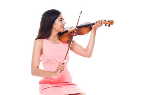istock Attractive young latino female playing the violin while sitting on stool 1083474904