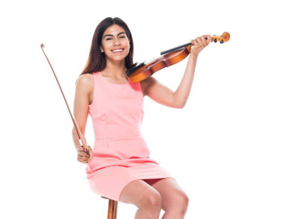istock Attractive young latino female playing the violin while sitting on stool 1083474918