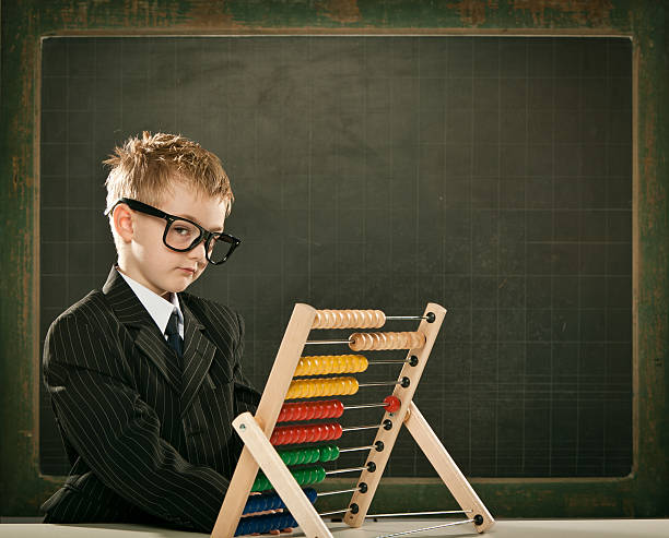 istock young serious scientist child with abacus and copyspace blackboa 108347617