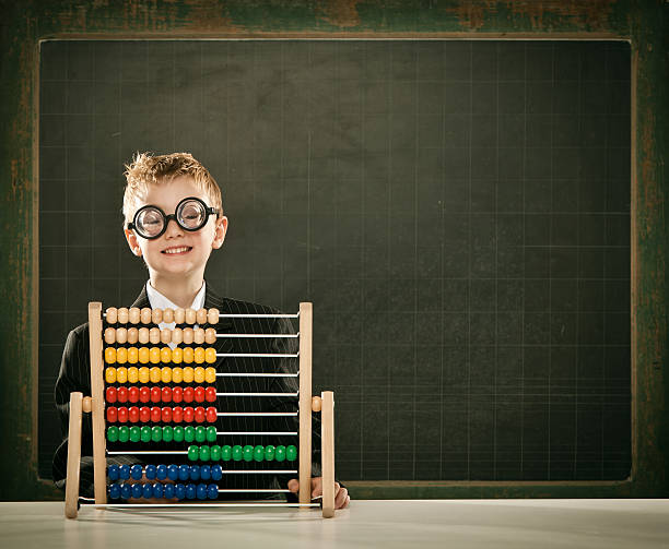 istock young happy scientist child with abacus and copyspace blackboard 108347650