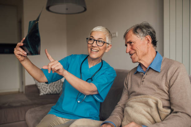 istock Smiling nurse showing an X-ray to a patient 1083476582