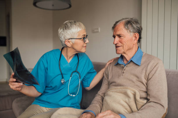 istock Nurse and patient looking at an x-ray image 1083476678