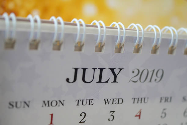 Monthly Spiral Desktop Calendar 2024 template: 3D illustration on empty grey background, large copy space. Sunday start week date planner in horizontal composition. Set of 12 Months. This is July.