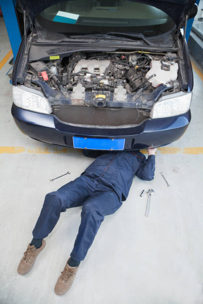 istock Chinese mechanic underneath car 1083477020