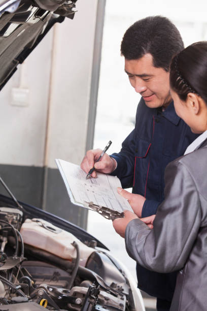 istock Chinese mechanic talking to customer 1083477224