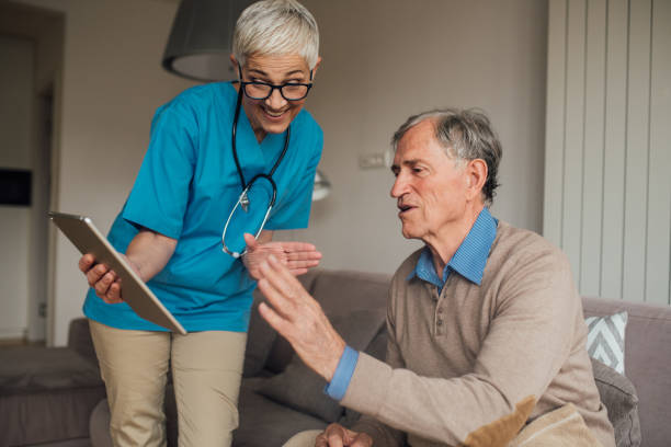 istock Nurse showing digital tablet to a man 1083477274
