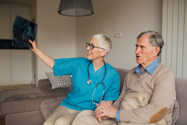 istock Happy nurse showing an X-ray image to a patient 1083478444