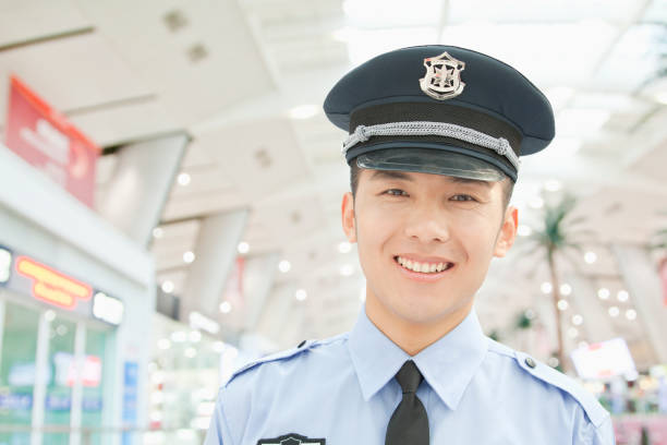 笑みを浮かべて中国人警察官 - concepts airport ideas watching ストックフォトと画像