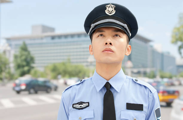 istock Smiling Chinese policeman looking up 1083478862